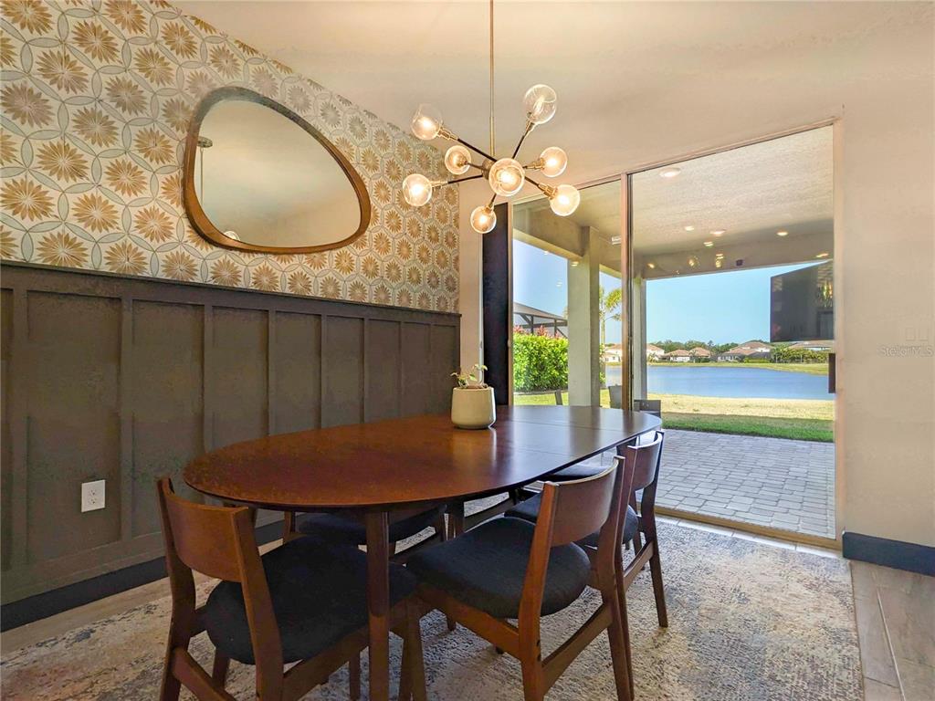 3324 Big Sky Way Lakewood Ranch, FL 34211 - Photo 9 of 49 a view of a dining room with furniture and wooden floor