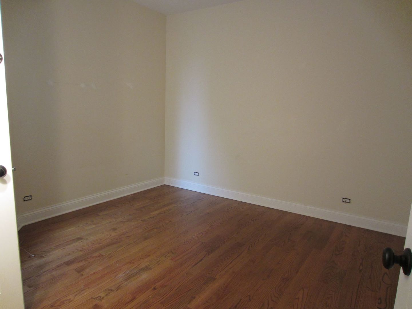 2117 West Irving Park Road, Unit 3R Chicago, IL 60618 - Photo 4 of 10 an empty room with wooden floor