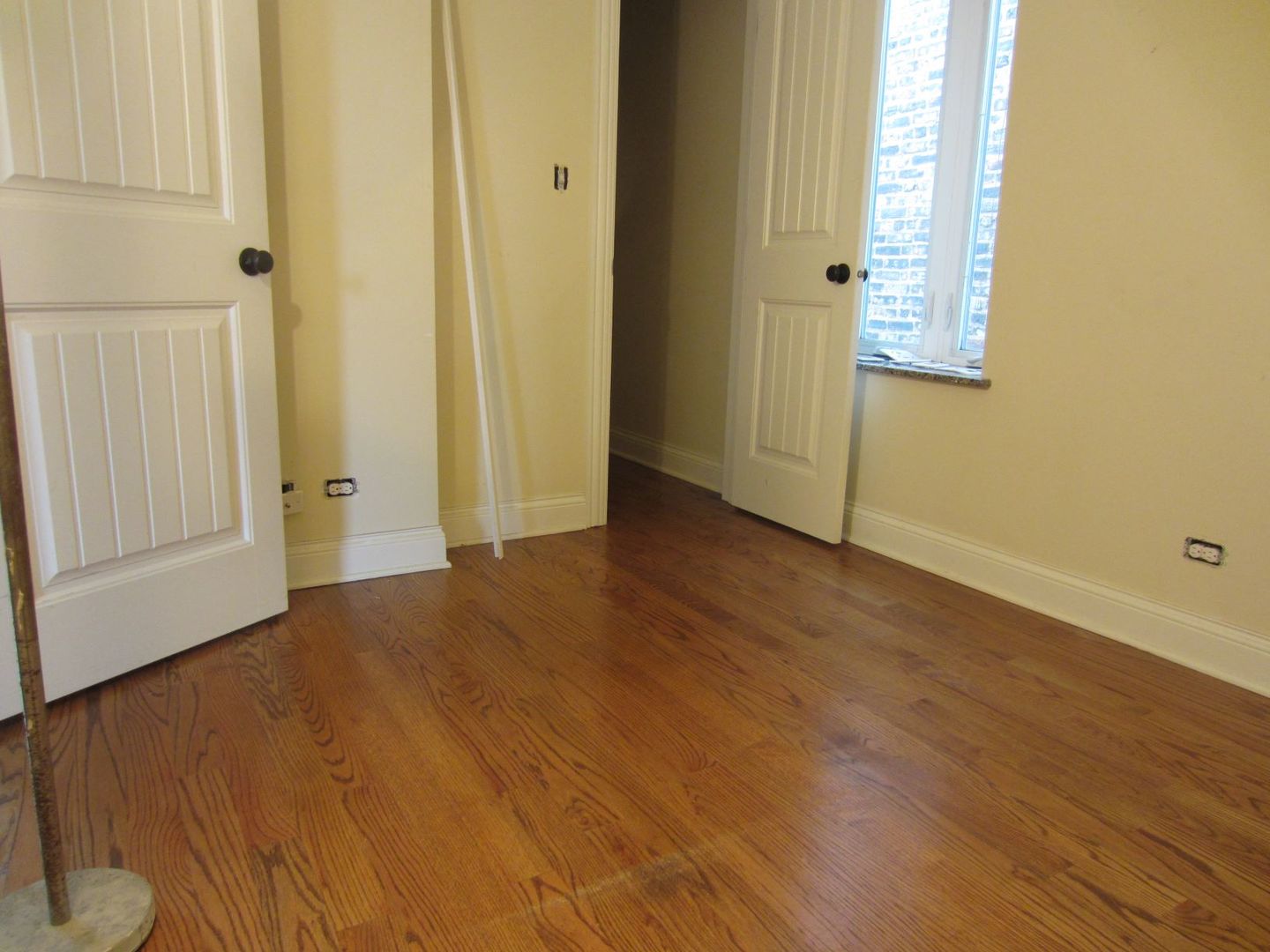 2117 West Irving Park Road, Unit 3R Chicago, IL 60618 - Photo 5 of 10 a view of an empty room with wooden floor and a window