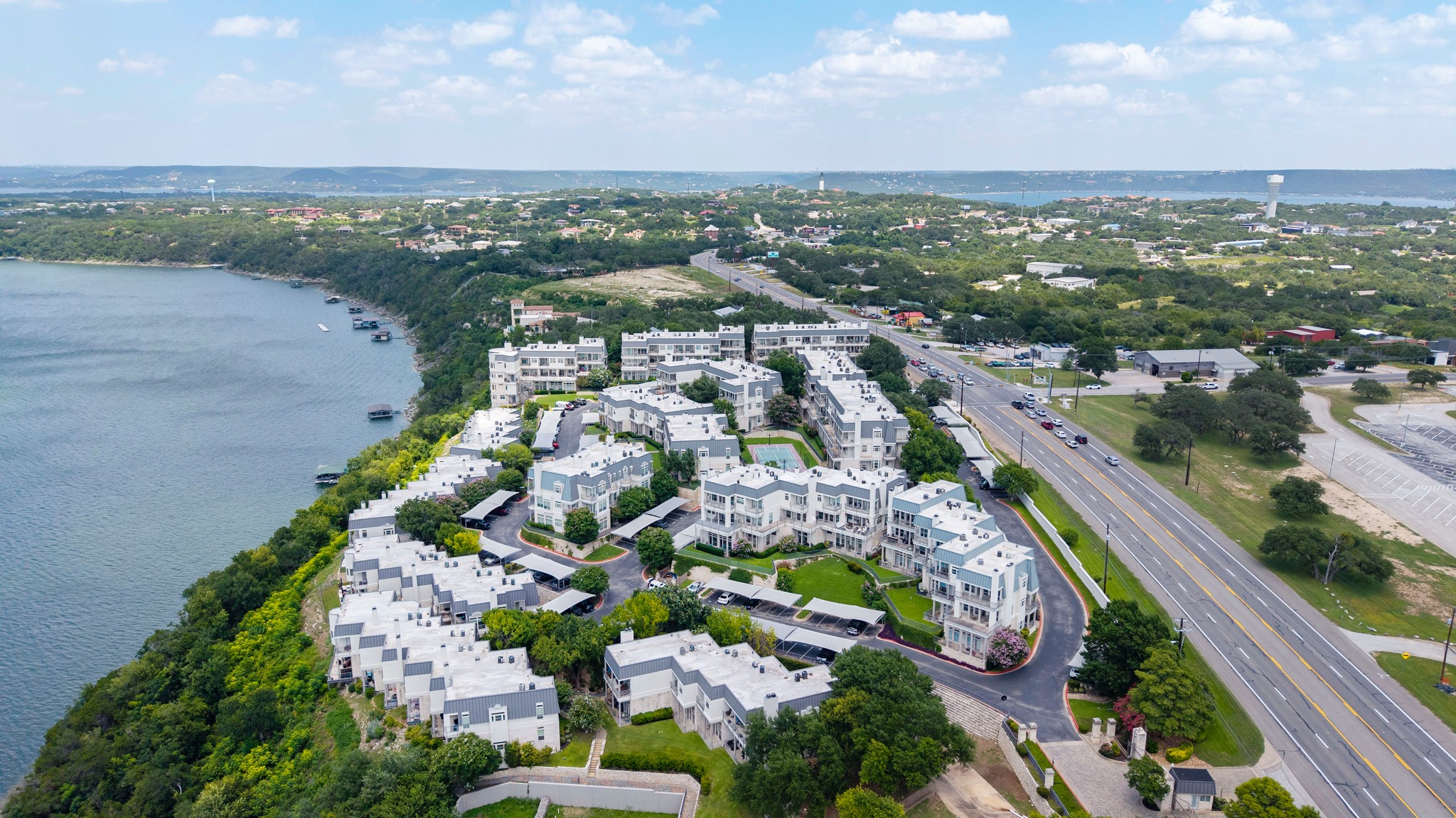 2918 Ranch Road 620 North, Unit S242 Austin, TX 78734 - Photo 34 of 35 Perched above the water, these multi-story residences offer captivating lakeside vistas and abundant outdoor spaces.