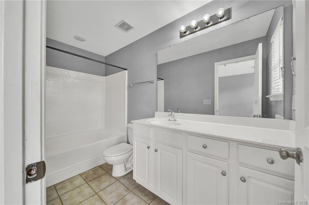 941 Copperstone Lane Fort Mill, SC 29708 - Photo 11 of 17 a spacious bathroom with a shower sink and mirror
