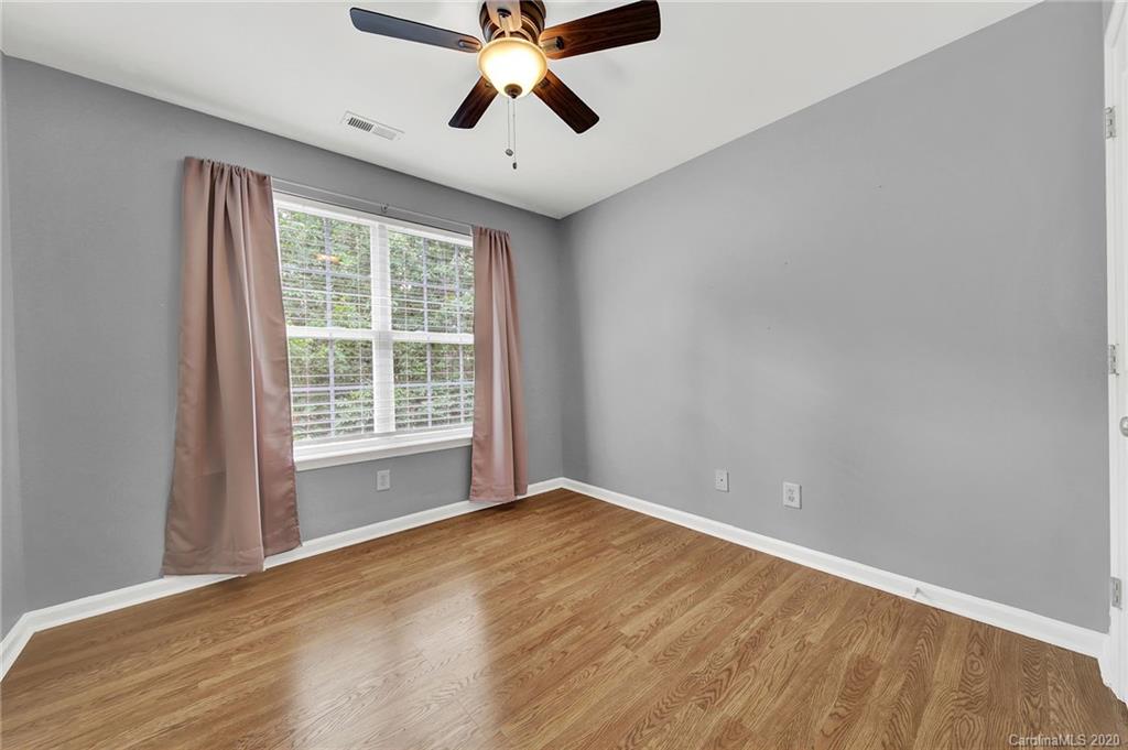 941 Copperstone Lane Fort Mill, SC 29708 - Photo 14 of 17 a view of an empty room with a window and a ceiling fan