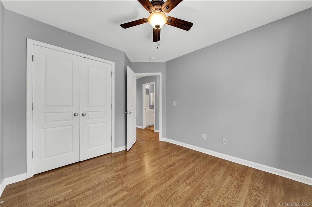 941 Copperstone Lane Fort Mill, SC 29708 - Photo 15 of 17 wooden floor in an empty room with a chandelier fan
