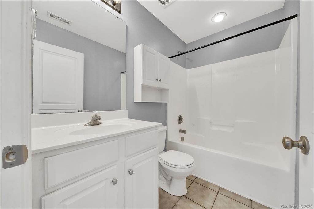 941 Copperstone Lane Fort Mill, SC 29708 - Photo 16 of 17 a bathroom with a sink a toilet and shower