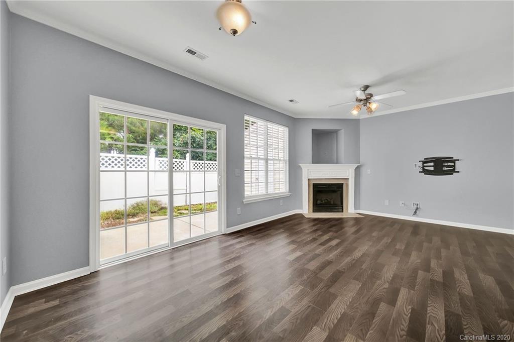 941 Copperstone Lane Fort Mill, SC 29708 - Photo 8 of 17 a view of an empty room with a window and wooden floor