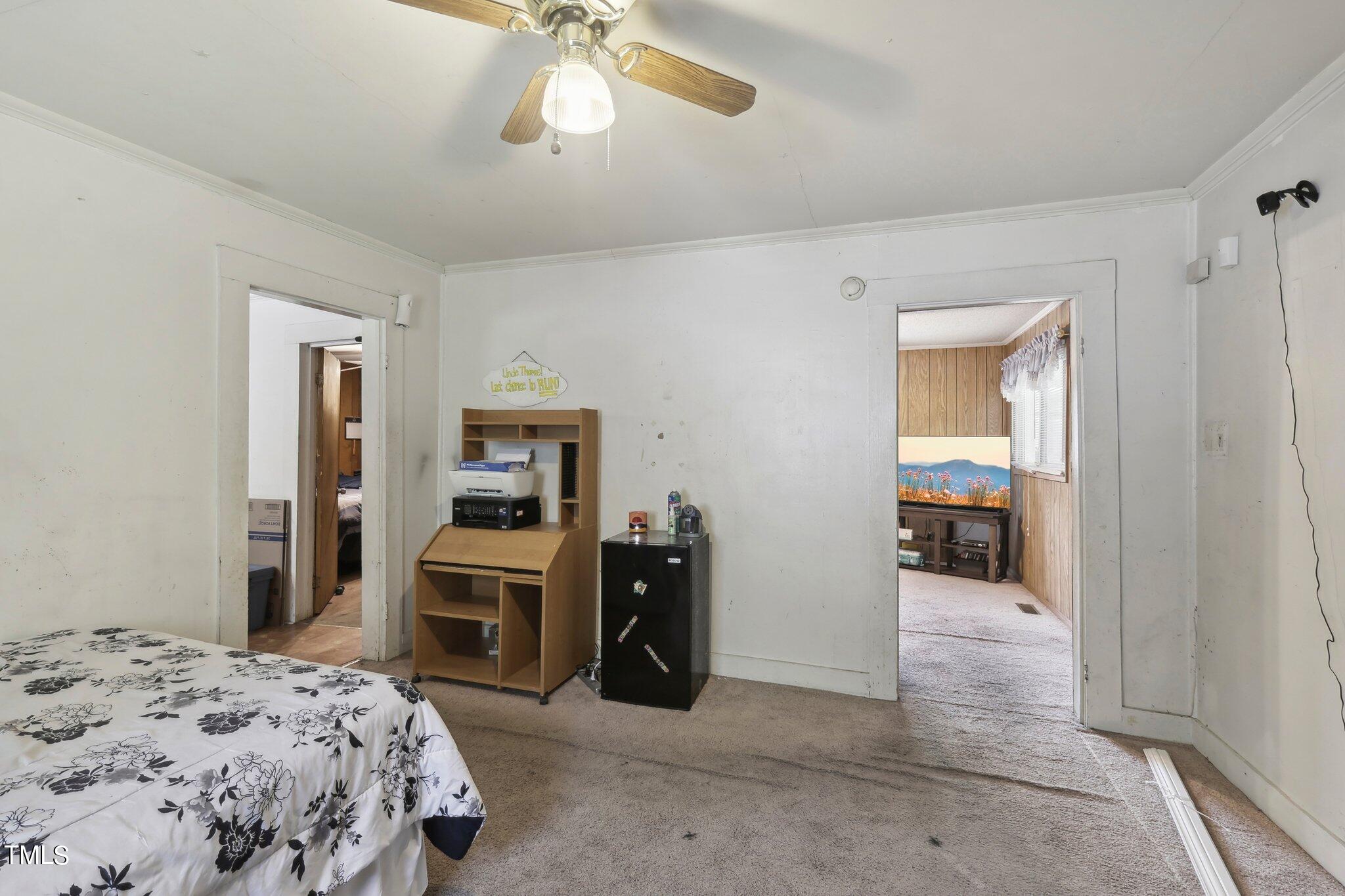 2917 State Street Durham, NC 27704 - Photo 12 of 22 a bedroom with a bed and a large mirror on the dresser