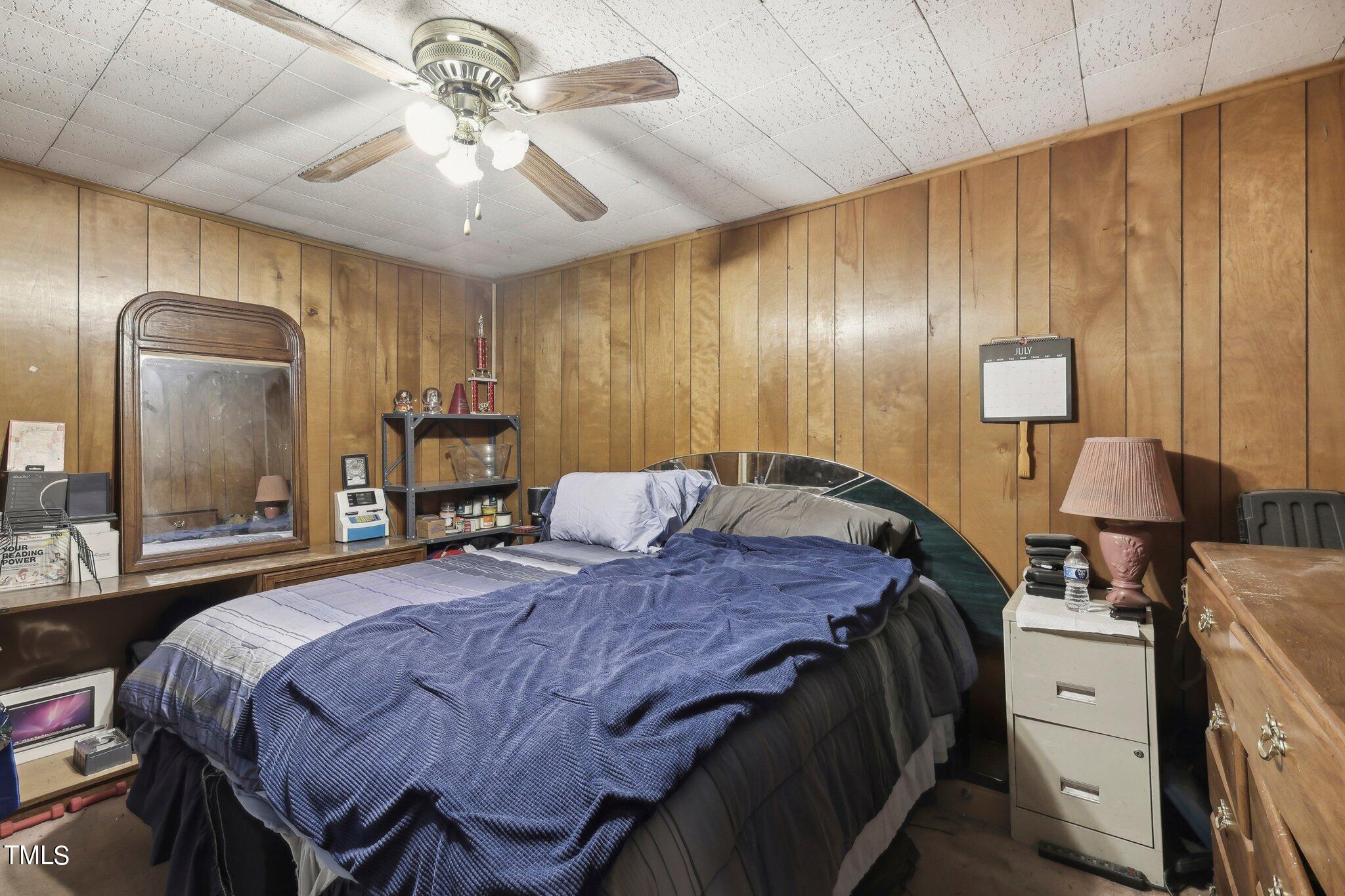 2917 State Street Durham, NC 27704 - Photo 14 of 22 a bedroom with a bed and a chandelier