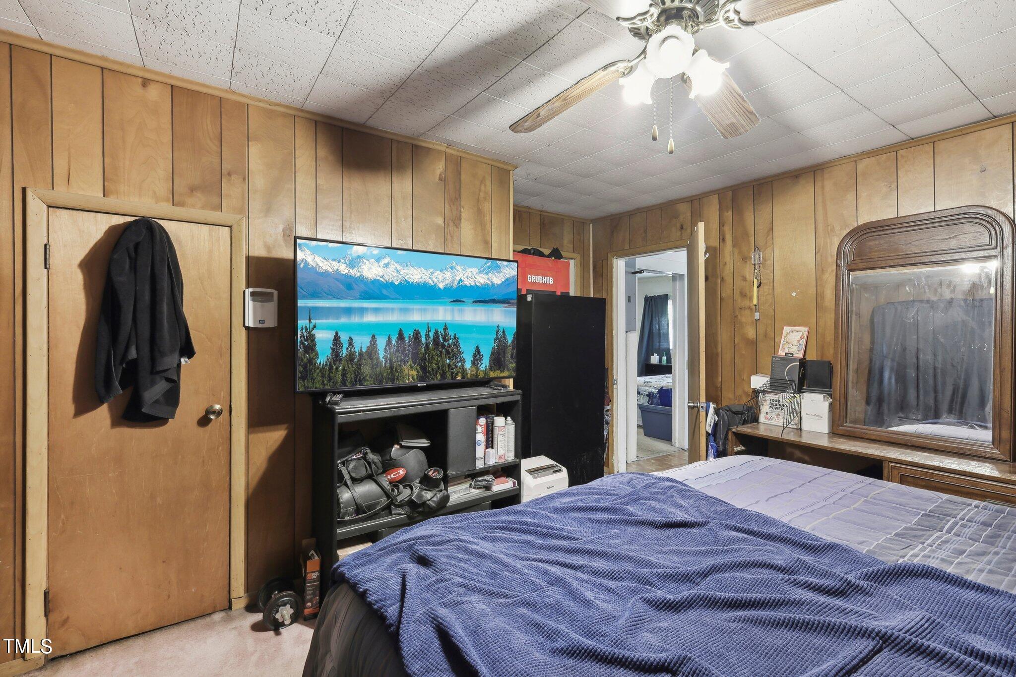 2917 State Street Durham, NC 27704 - Photo 15 of 22 a bedroom with a bed and a flat screen tv