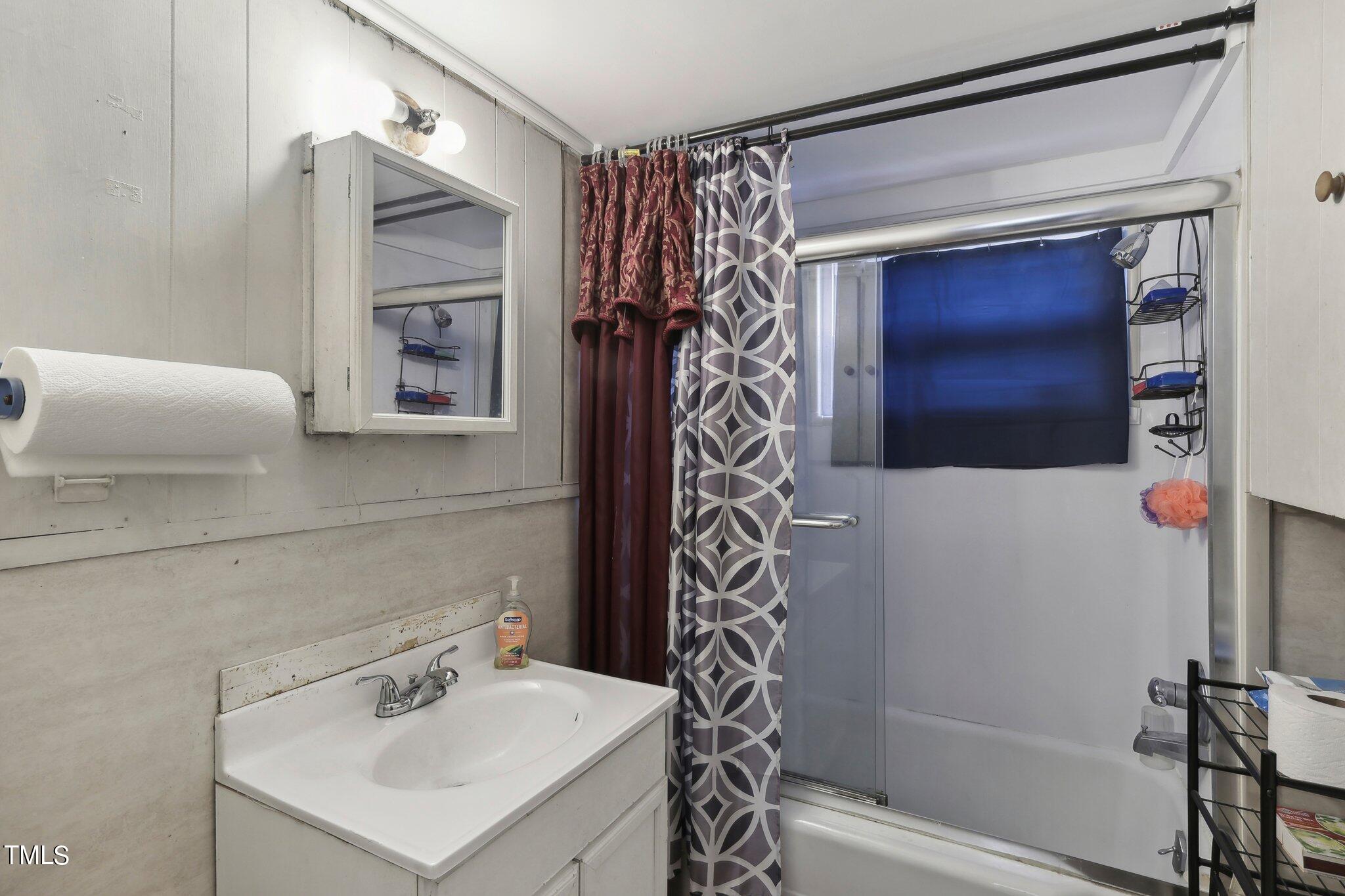 2917 State Street Durham, NC 27704 - Photo 18 of 22 a bathroom with a shower curtain and a sink