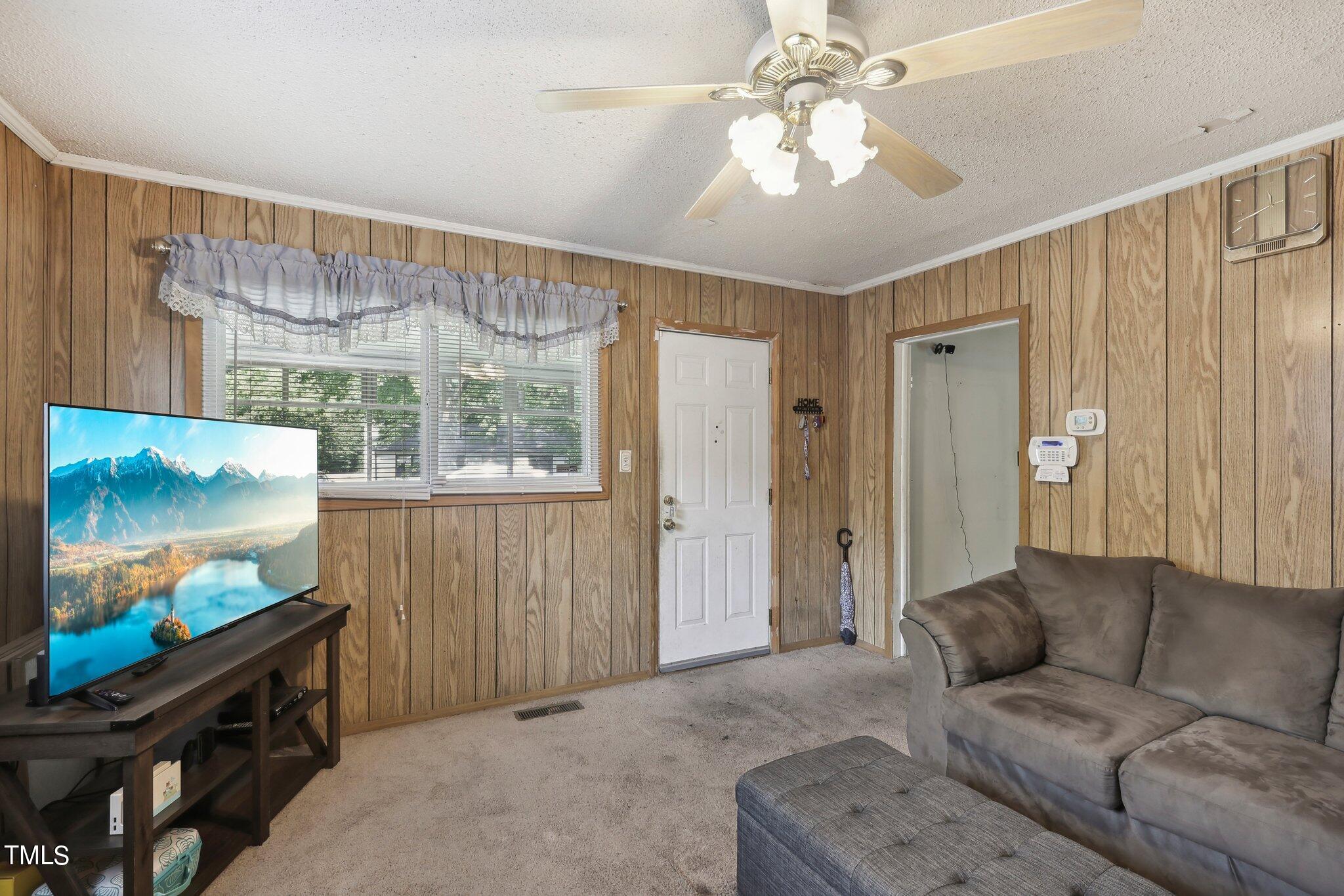 2917 State Street Durham, NC 27704 - Photo 5 of 22 a living room with furniture and a flat screen tv
