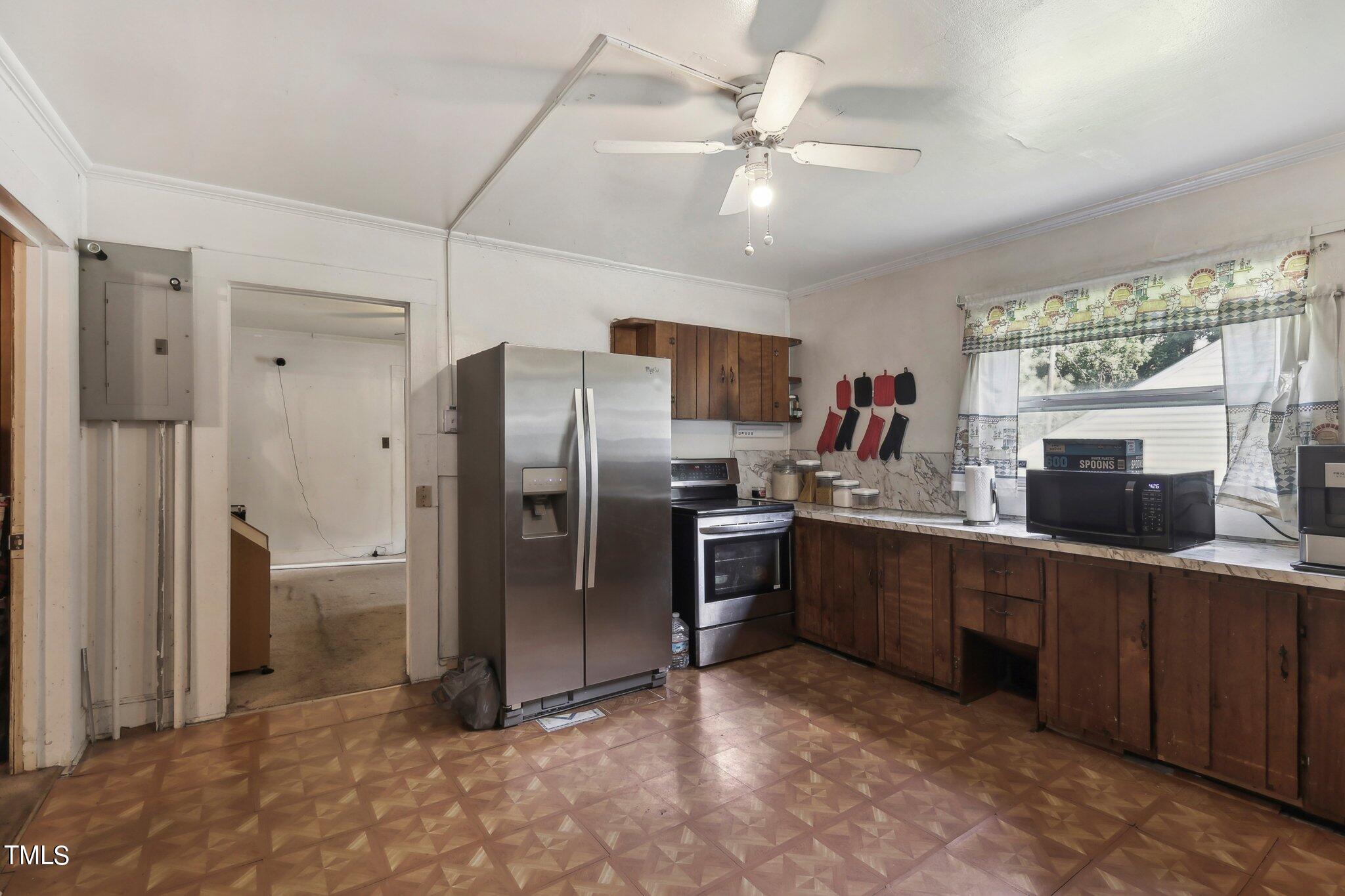 2917 State Street Durham, NC 27704 - Photo 7 of 22 a kitchen with stainless steel appliances a refrigerator and a sink