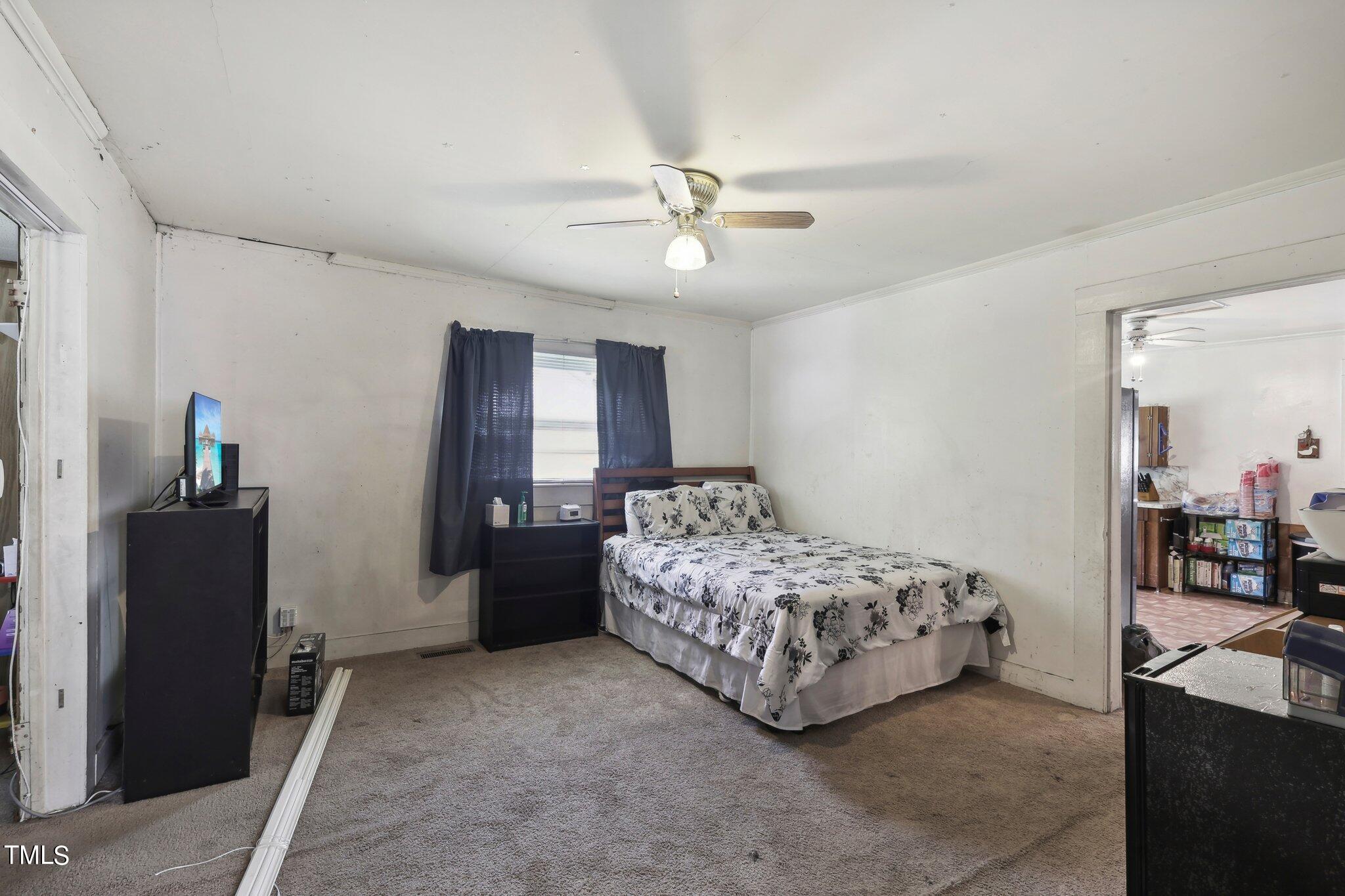 2917 State Street Durham, NC 27704 - Photo 8 of 22 a bedroom with a bed and a chandelier