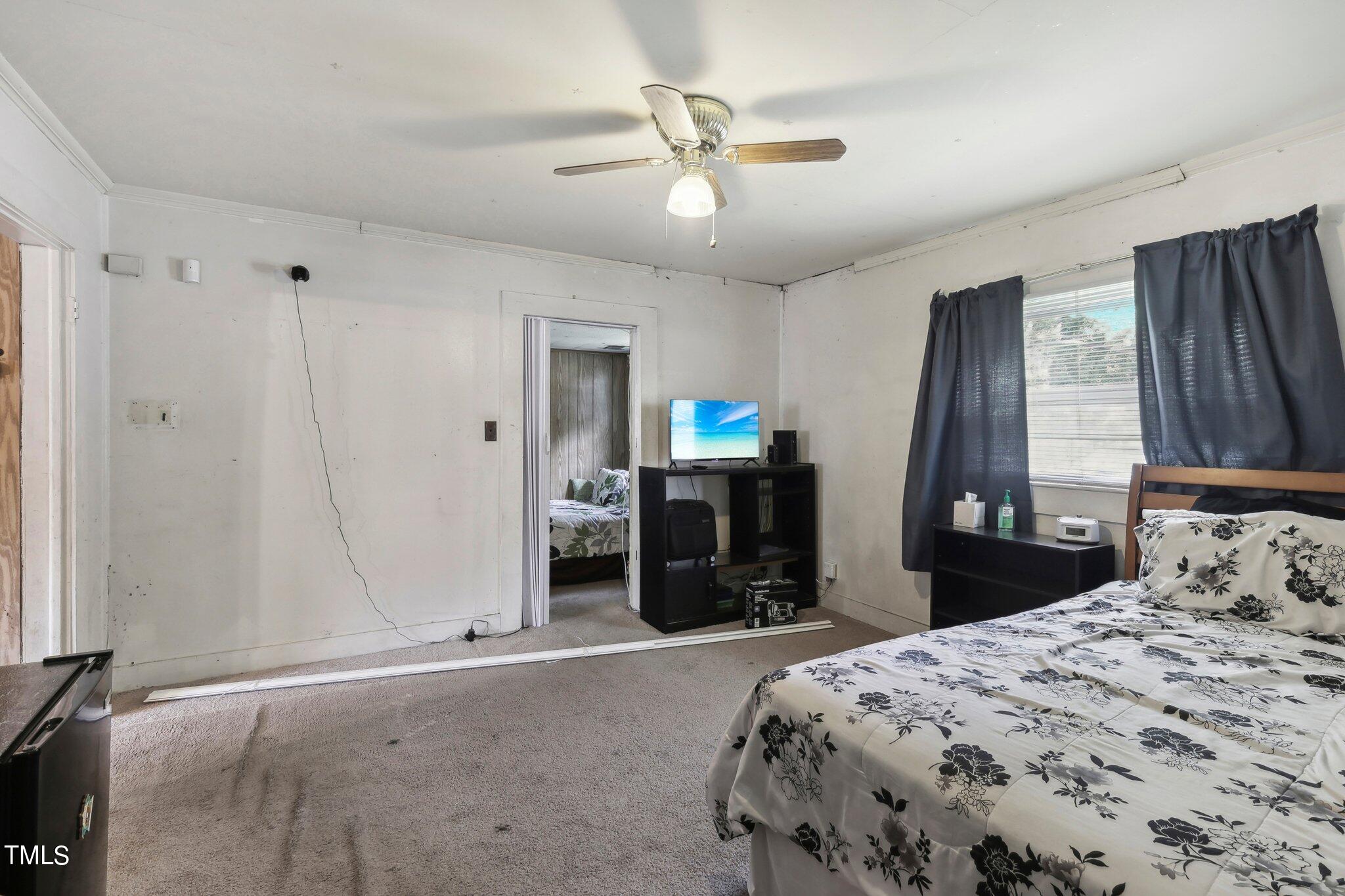 2917 State Street Durham, NC 27704 - Photo 9 of 22 a bedroom with a bed and a chandelier