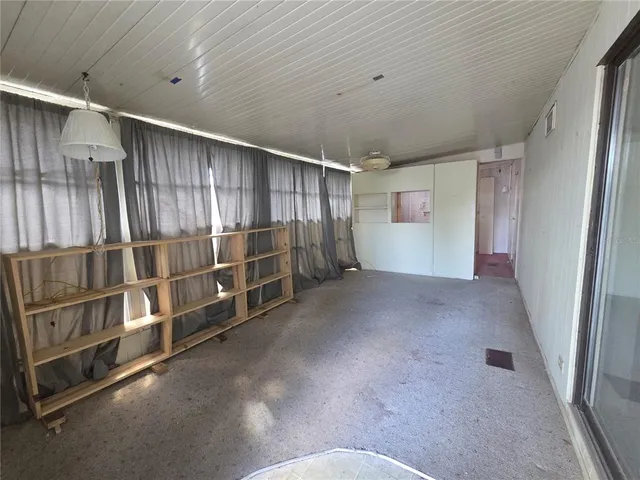 a view of an empty room with windows