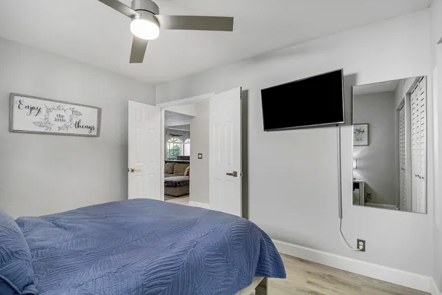 a bedroom with a large bed and a flat screen tv