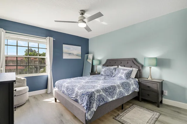 a bedroom with a large bed and a window