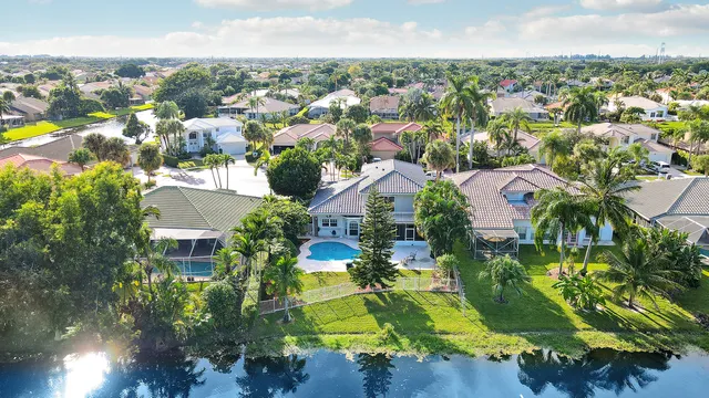 an aerial view of residential houses with outdoor space and swimming pool