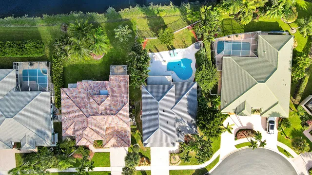 an aerial view of a house with garden space and street view