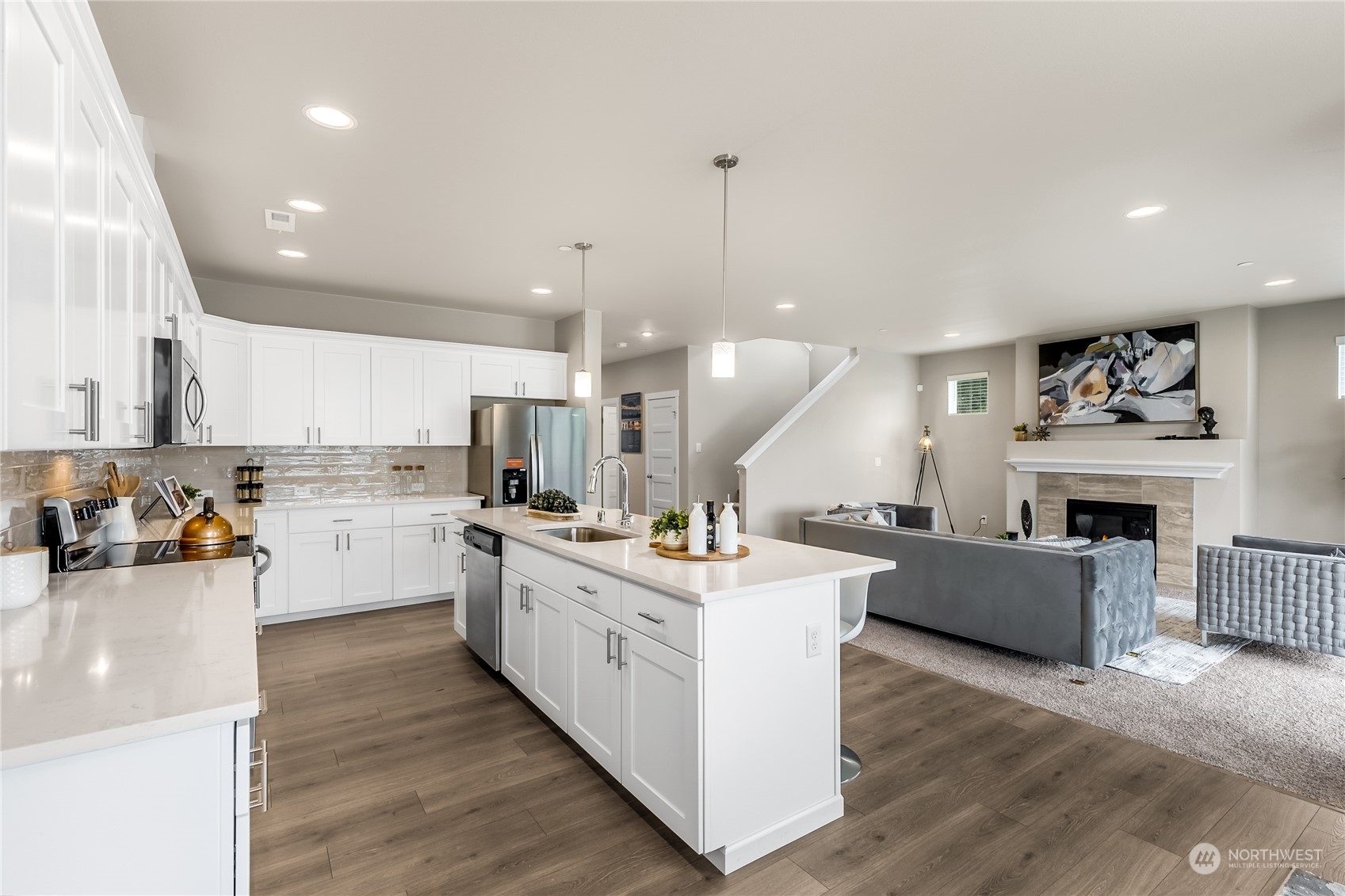 3040 Stephanie Loop Northeast Lacey, WA 98516 - Photo 5 of 14 a kitchen with a lot of counter top space and a wooden floor