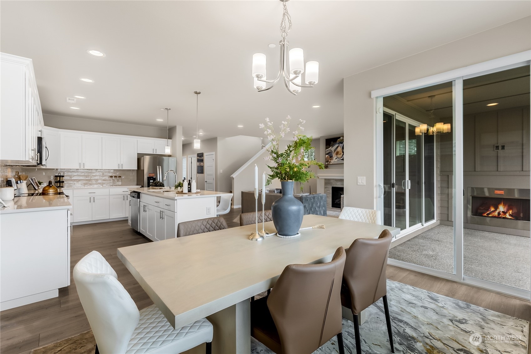 3040 Stephanie Loop Northeast Lacey, WA 98516 - Photo 7 of 14 a open dining room with kitchen island stainless steel appliances furniture a chandelier and kitchen view