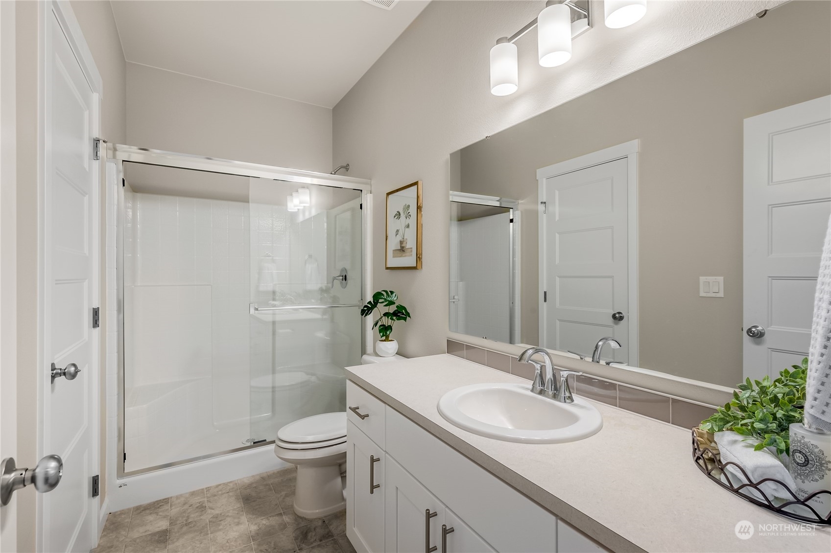 3040 Stephanie Loop Northeast Lacey, WA 98516 - Photo 9 of 14 a bathroom with a granite countertop sink toilet a large mirror and shower