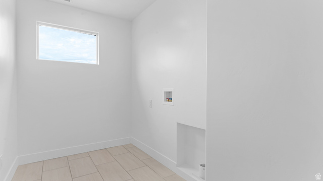 4170 North 560th West, Unit 6 Tooele, UT 84074 - Photo 17 of 20 Utility room featuring light-toned tile flooring, a horizontal window, and white baseboards