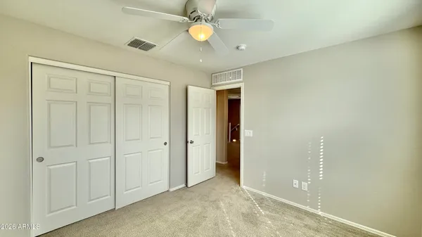 an empty room with windows and closet