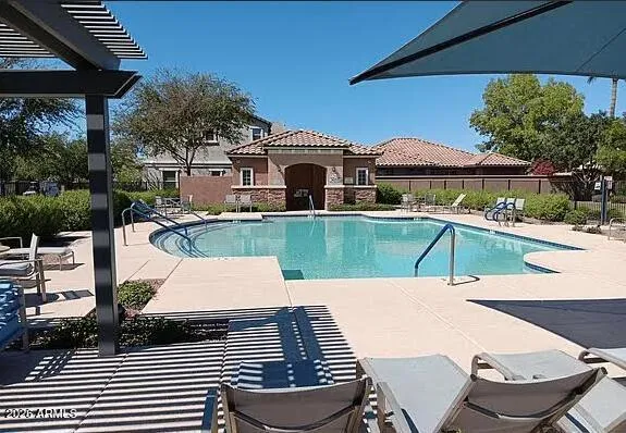 a view of a patio with table and chairs under an umbrella