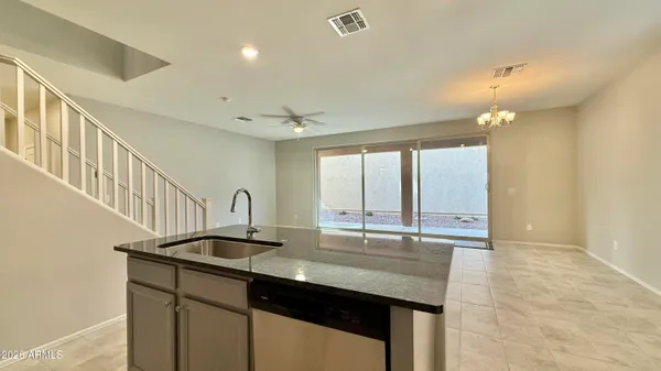 a kitchen with sink cabinets and chandelier