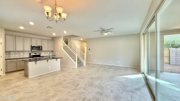 a view of kitchen with sink microwave and refrigerator