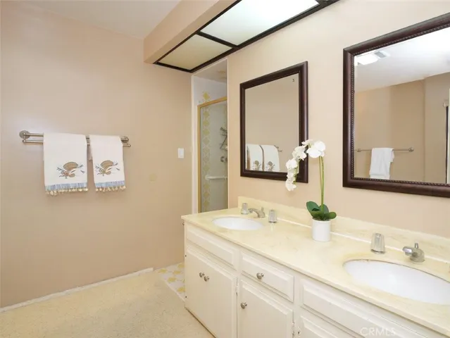 a bathroom with a double vanity sink mirror and