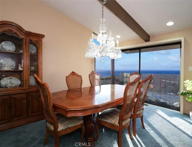 a view of a dining room with furniture and chandelier