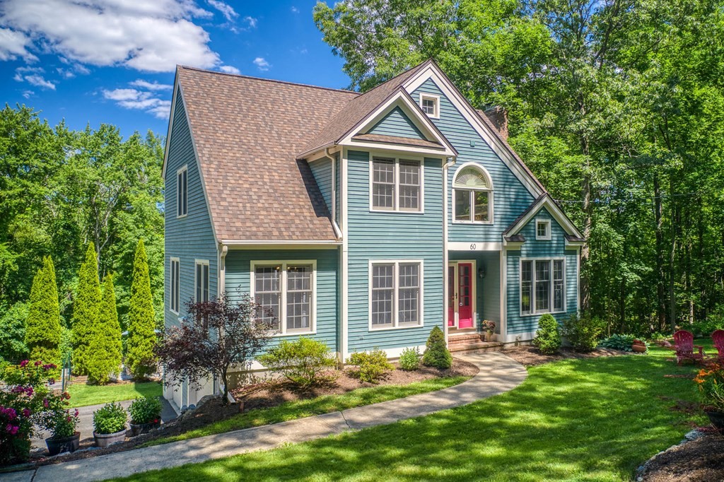60 Woobly Road Bolton, MA 01740 - Photo 1 of 1 a front view of a house with a yard table and chairs