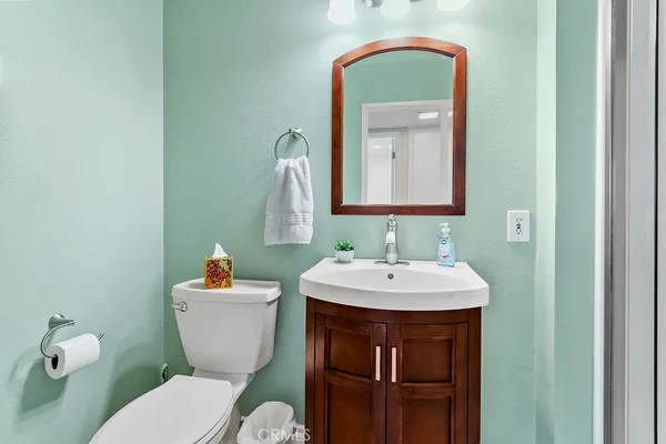 a bathroom with a toilet a sink and a mirror