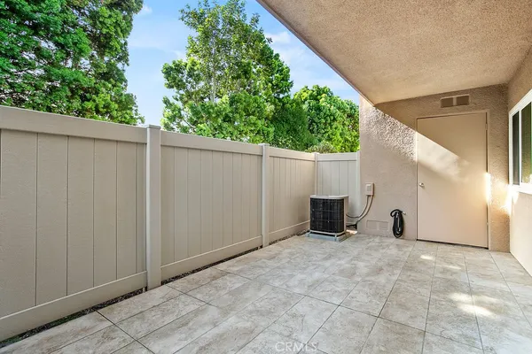 a view of a back yard with wooden fence