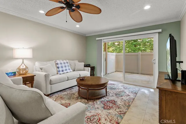 a living room with furniture a window and a flat screen tv