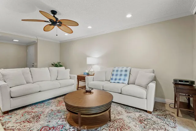 a living room with furniture a rug and a lamp