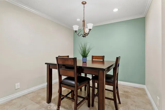 a dining room with a table and chairs