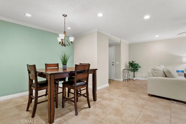 a dining room with furniture and a chandelier