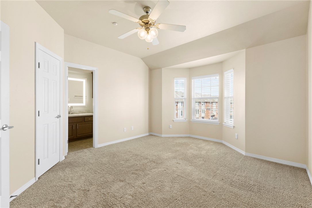 1198 Jones-Butler Road, Unit 705 College Station, TX 77840 - Photo 19 of 34 Unfurnished bedroom with ensuite bath, light carpet, and ceiling fan