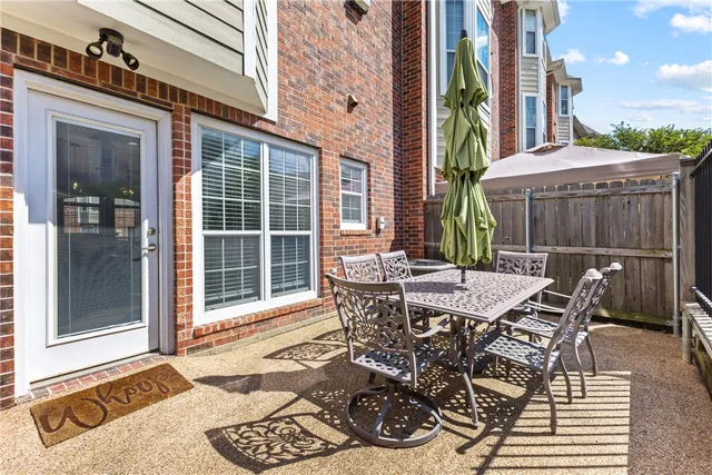 a view of a patio with table and chairs and potted plants