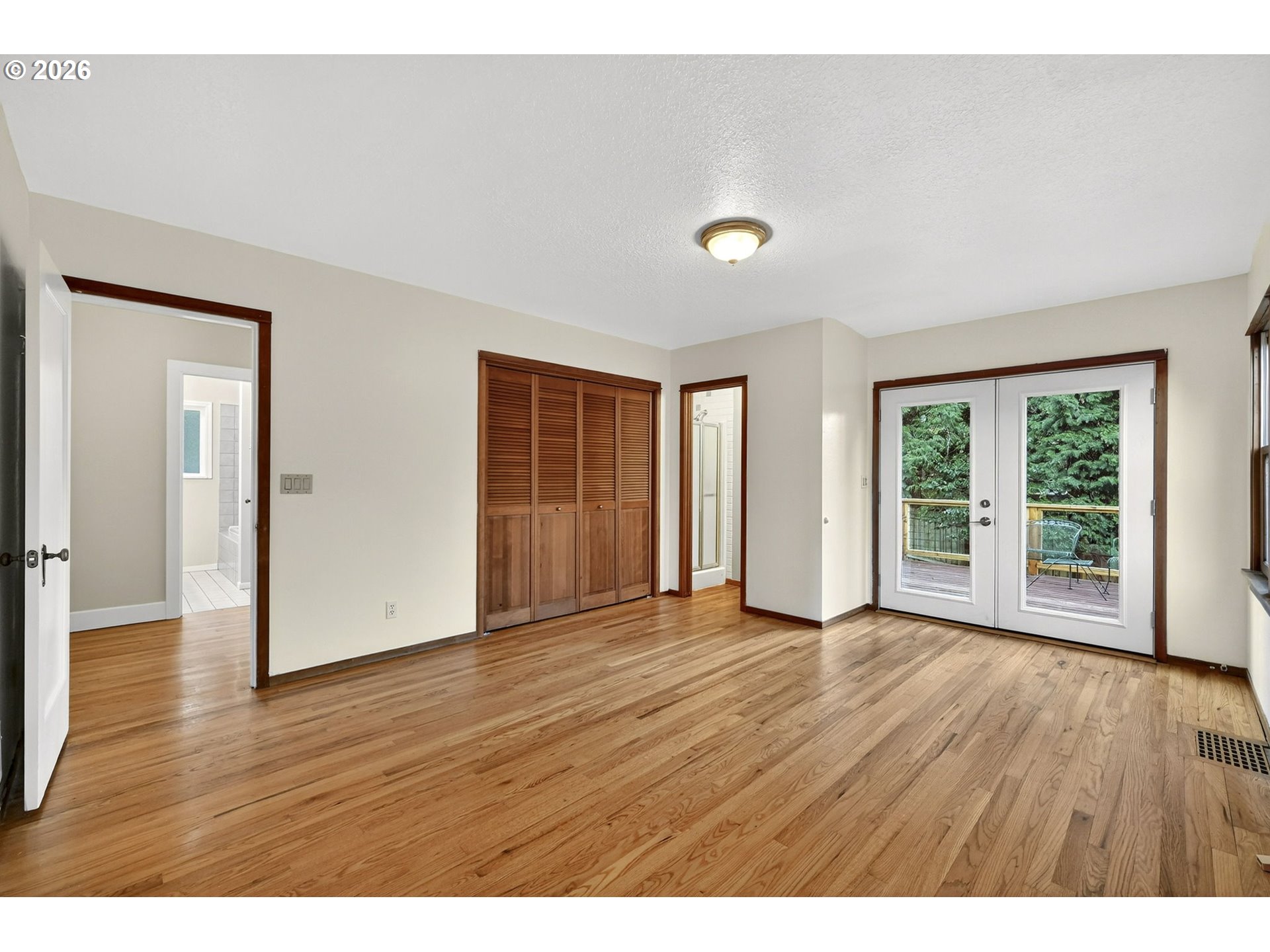 11811 Southwest 34th Avenue Portland, OR 97219 - Photo 14 of 39 a view of an empty room with wooden floor and windows