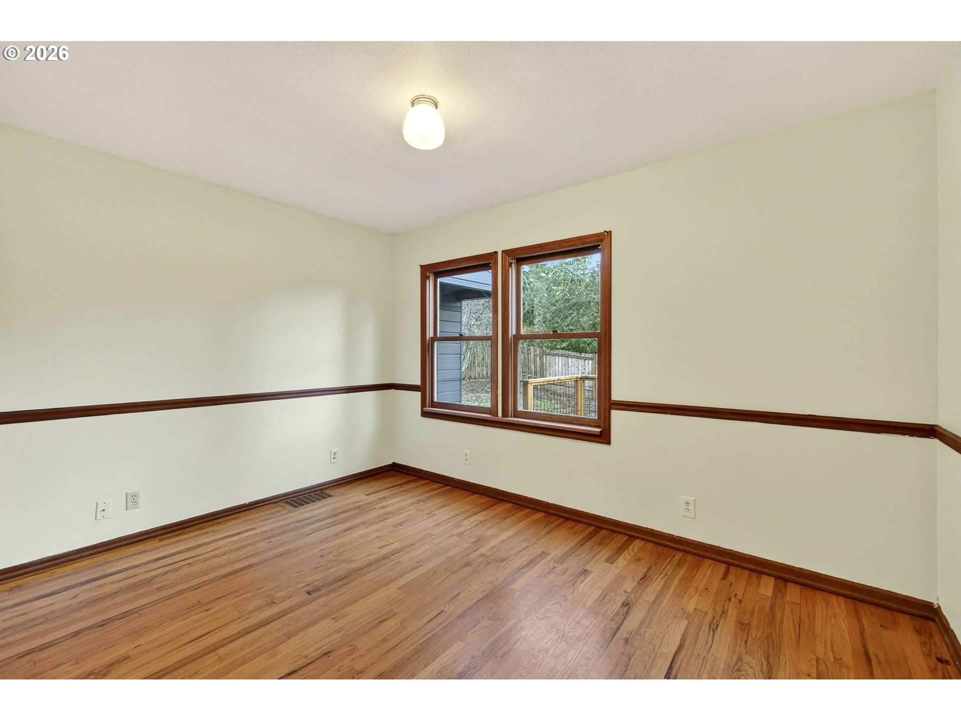 11811 Southwest 34th Avenue Portland, OR 97219 - Photo 16 of 39 a view of an empty room with wooden floor and a window