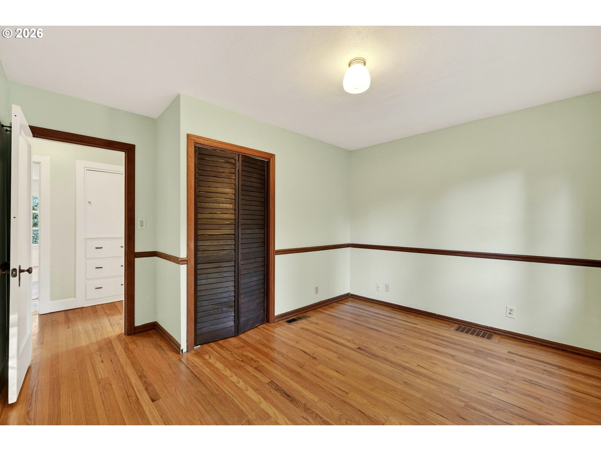 11811 Southwest 34th Avenue Portland, OR 97219 - Photo 17 of 39 a view of an empty room with wooden floor