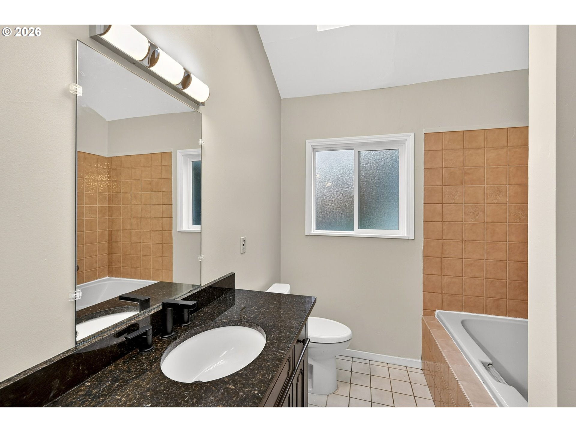 11811 Southwest 34th Avenue Portland, OR 97219 - Photo 18 of 39 a bathroom with a sink a toilet and mirror