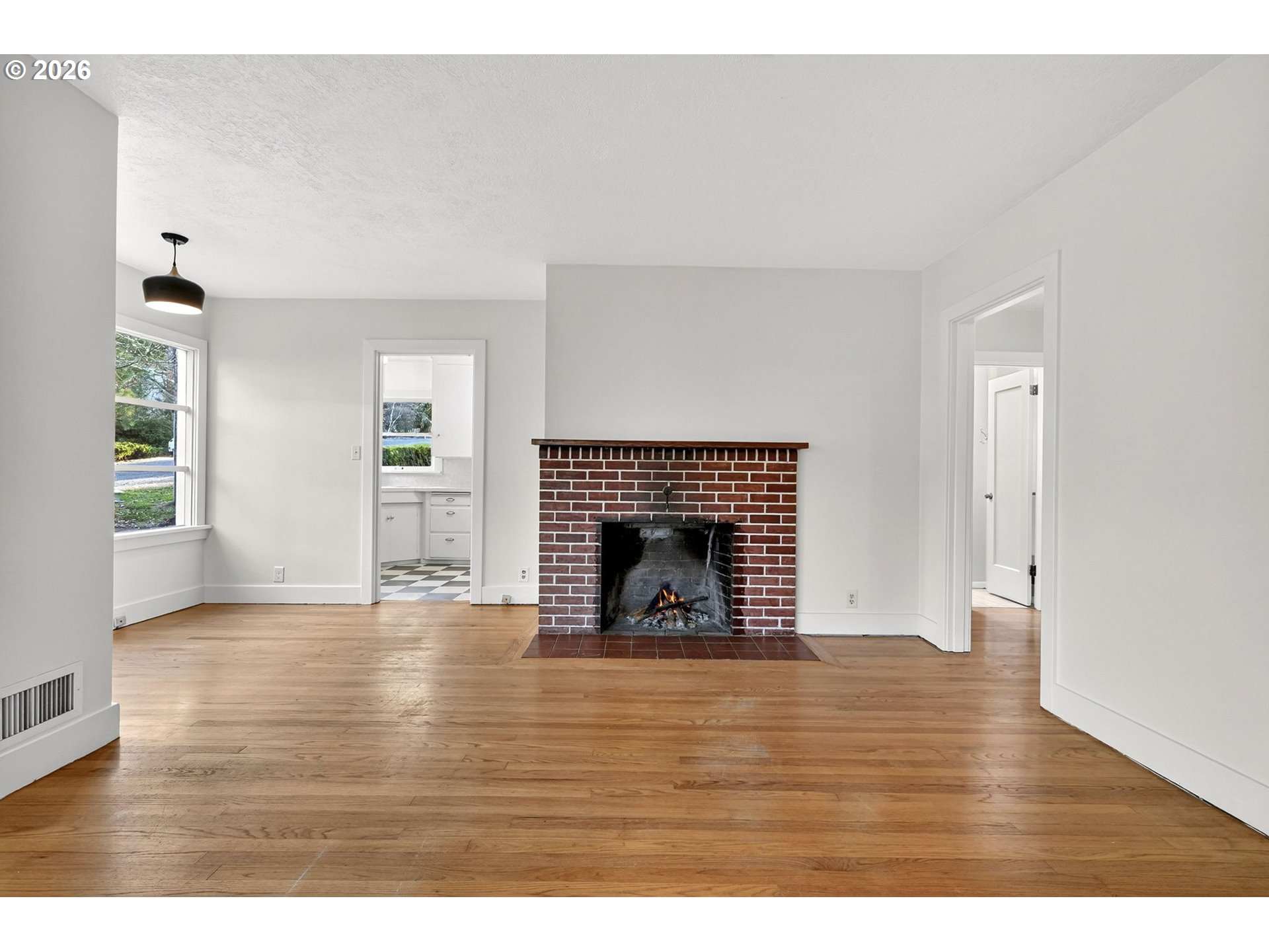 11811 Southwest 34th Avenue Portland, OR 97219 - Photo 7 of 39 a view of empty room with wooden floor and fireplace