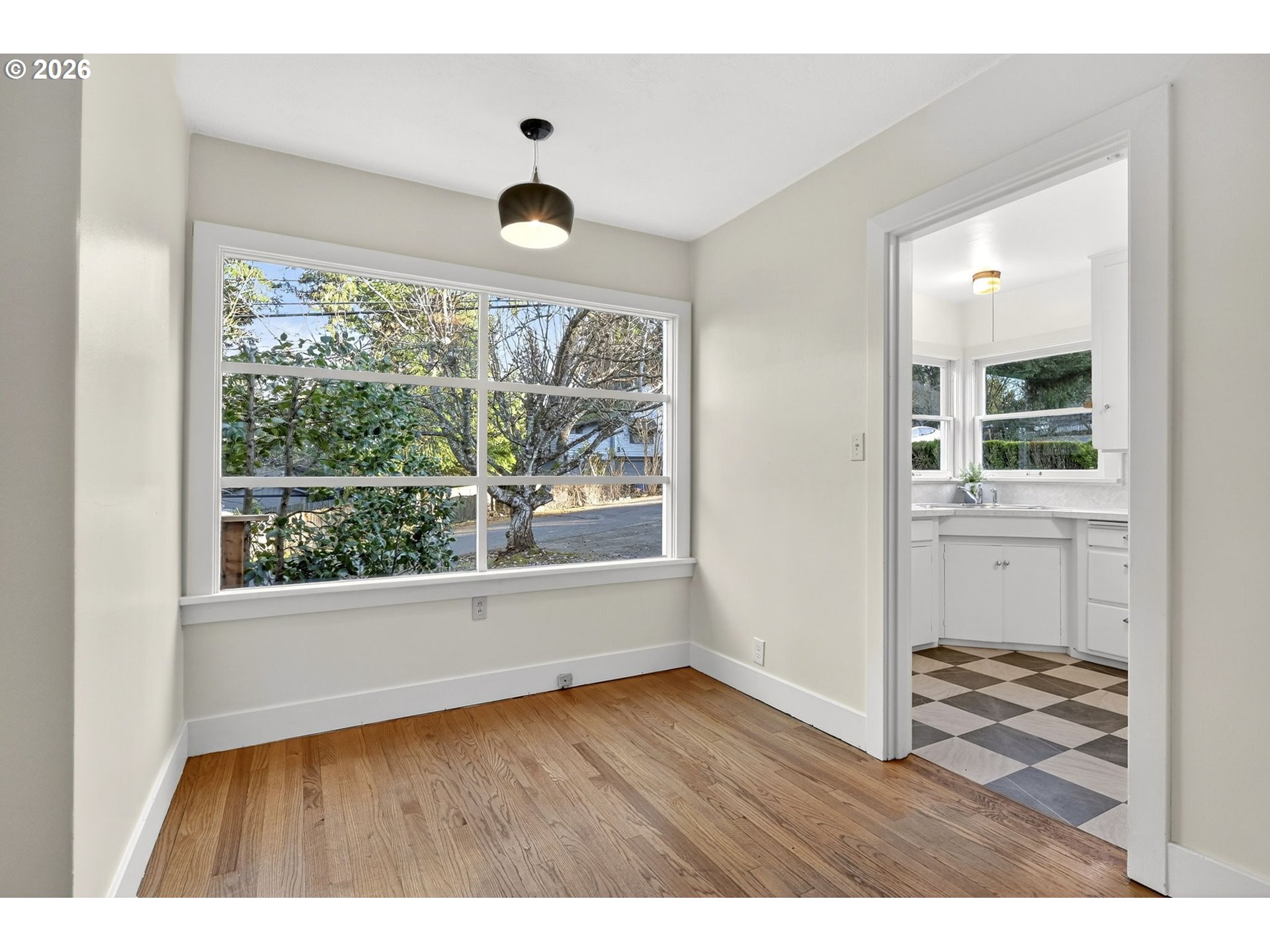 11811 Southwest 34th Avenue Portland, OR 97219 - Photo 8 of 39 an empty room with wooden floor and windows
