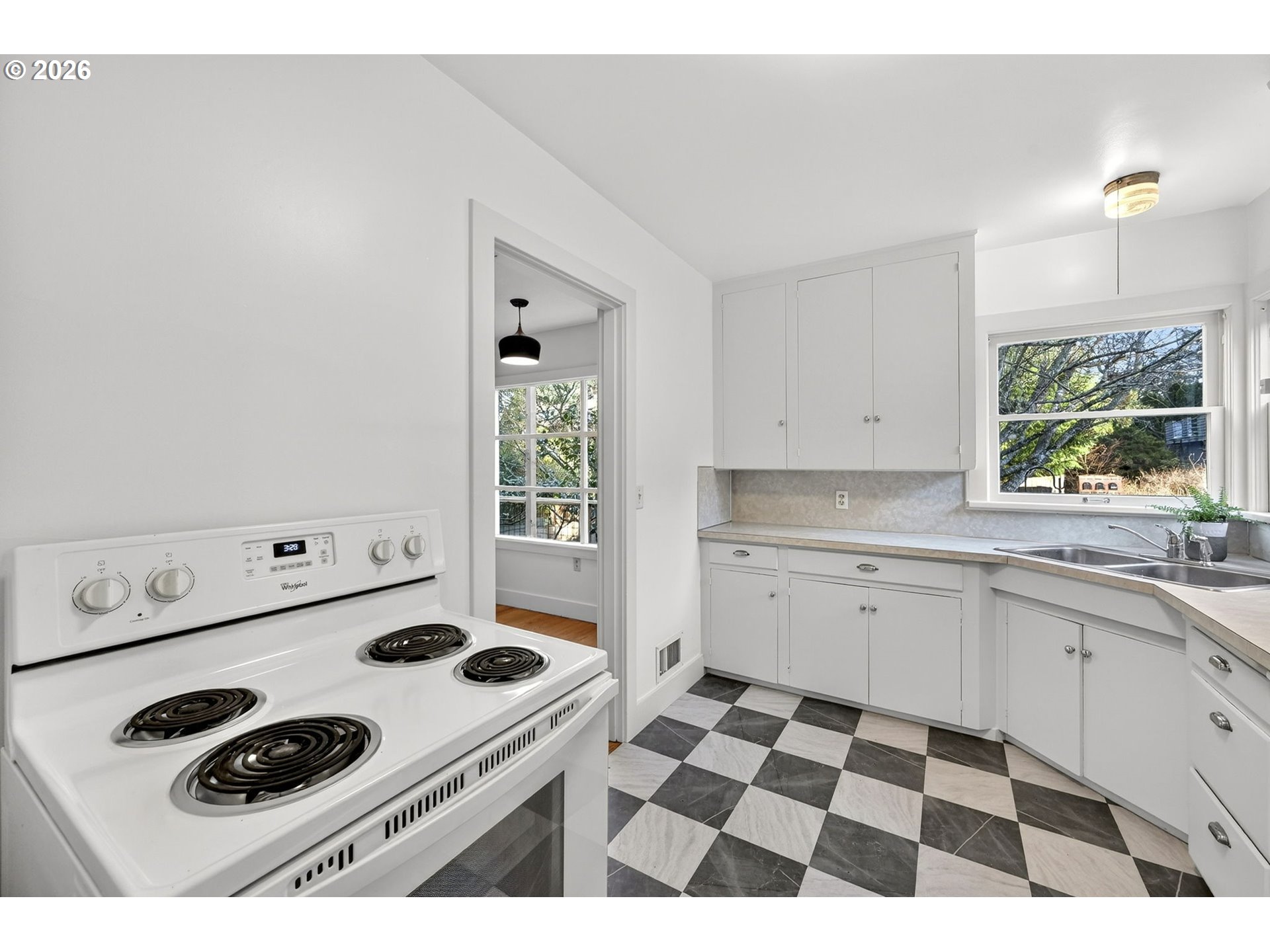 11811 Southwest 34th Avenue Portland, OR 97219 - Photo 10 of 39 a kitchen with a sink a stove and cabinets