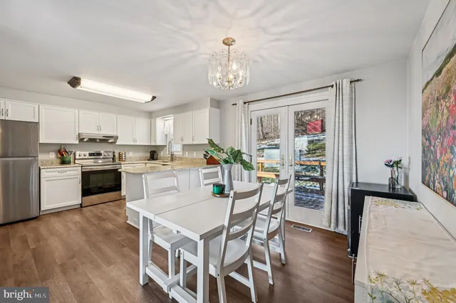 a dining room with furniture and wooden floor