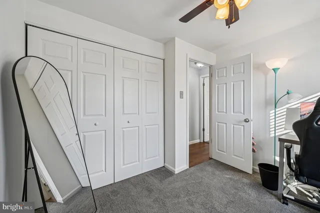 a spacious bedroom with a large bed and a chandelier